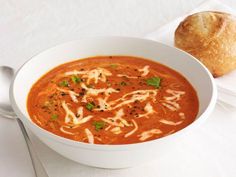 a bowl of soup with bread on the side