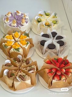 four different types of cakes and pastries on plates with brown paper bags tied around them