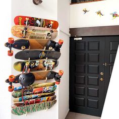 there are many skateboards hanging on the wall