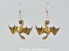 "This design began as a clay sculpture created by hand, which I recreated in 3D. Each Dragon is 3D printed on my in-house resin printer in beautiful detail. They are then hand painted and given several coats of varnish to protect the paint. The earrings are complete with lead-free and nickel-free dangle-style findings and are ready to wear! The photos are for reference only, the exact piece you receive will be different, because they are all hand-made. There may be small imperfections, but they add the the unique character of the piece. THIS ITEM IS NOT CURRENTLY IN-STOCK. It will be custom made-to-order in a process which will be completed within (or before) the \"READY TO SHIP IN\" estimate found in this listing." Silhouette Necklace, Fantasy Earrings, Black And White Earrings, Quirky Jewelry, Dragon Earrings, Dragon Figurines, Gold Dragon, Dragon Necklace, Earrings Antique