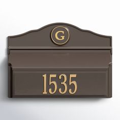 a brown mailbox with the number 535 on it's front and side