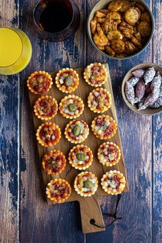 small appetizers are arranged on a cutting board