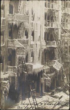 an old black and white photo of a building that has icicles on the windows