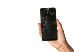 a hand holding a cell phone with a cracked screen on it's side, against a white background