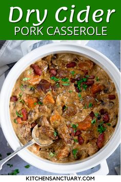 a white bowl filled with meat and vegetables next to a green sign that says dry cider pork casserole