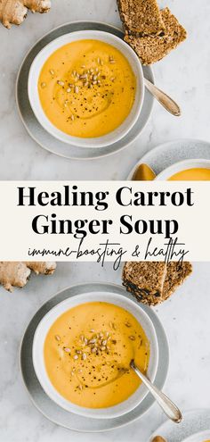 two white bowls filled with carrot ginger soup on top of a marble table next to bread