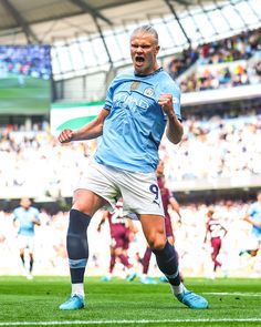 the soccer player is celebrating his goal in front of an audience at a sporting event