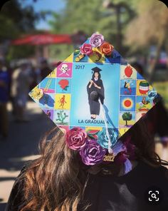 a woman wearing a graduation cap decorated with pictures and flowers on it's head