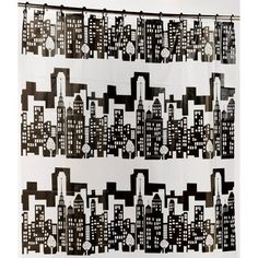 a black and white cityscape shower curtain hanging on a wall