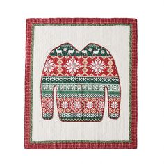 a red and green christmas sweater with an elephant on it's chest is shown