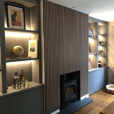 a living room filled with furniture and a fire place next to a wall mounted tv