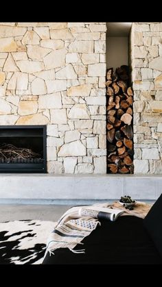 an instagram photo of a fireplace with logs in it