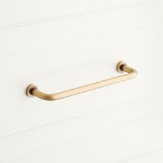 an image of a brass towel bar on the wall