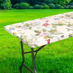 an ironing board on top of a table in the middle of a grassy field