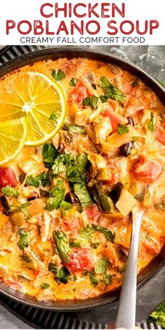 chicken poblano soup in a skillet with lemon wedges and cilantro