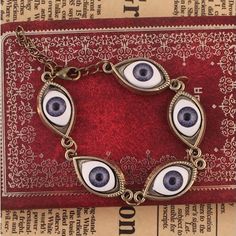 Harajuku Devil Eyes Bracelet from Harajuku fashion on Storenvy Devil Eyes, Future Punk, Slasher Horror, Things I Wanna Buy, Devil Eye, Witch Fashion, Me Board, Backless Prom Dresses, Prom Dresses Online