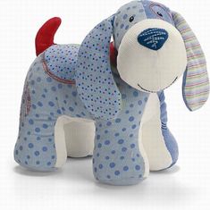 a stuffed dog with blue and white polka dots on it's body, standing upright