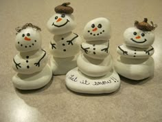 four snowmen sitting on top of rocks with the words i cannot't sit there