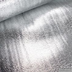 shiny silver metallic fabric textured on top of each other