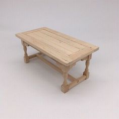 a small wooden table sitting on top of a white floor