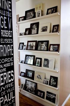 a white shelf with black and white pictures on it