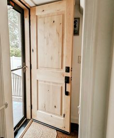 an open door with a rug on the floor