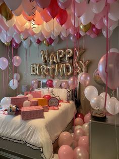 a bedroom decorated with balloons and gifts