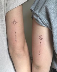 two people with matching tattoos on their arms, one has a sun and the other has a moon