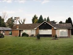 a house in the middle of a grassy field