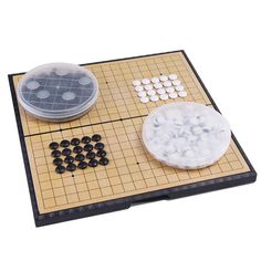 a board game set up with plastic plates and dices on it, ready to play