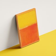 an orange and yellow painting on a white wall