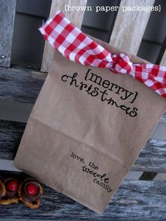 a brown paper bag sitting on top of a wooden bench next to cookies and candy