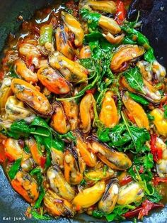 a pan filled with shrimp and spinach covered in sauce