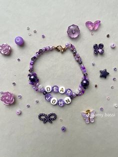 a bracelet with beads and charms that read dear mom on it, surrounded by other items