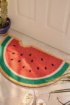 a watermelon rug on the floor next to shoes