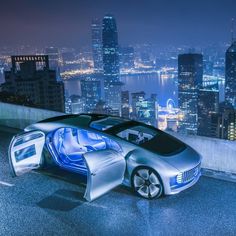 an electric car on the road in front of a city at night