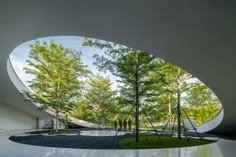 the inside of a building with trees and grass