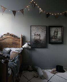 a bedroom with two pictures hanging on the wall