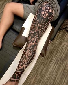 a man's leg with tattoos on it