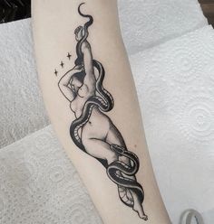 a woman with a snake tattoo on her arm