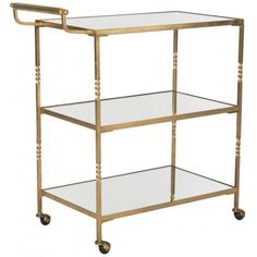 a gold metal and glass serving cart with three shelves on each side, one shelf has two