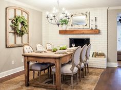 an image of a dining room table with chairs and a fireplace in the back ground