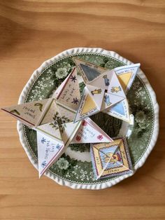 a plate that has some cards in it on top of a wooden table with other items