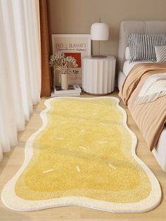 a yellow area rug on the floor in a bedroom