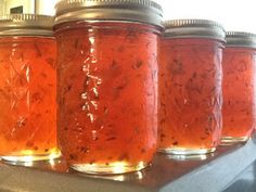 several jars filled with food sitting on top of a stove