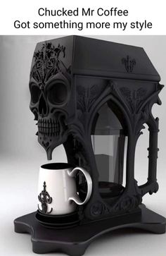 a coffee cup holder with a skull on it and a mug in front of it