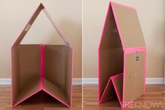 an open cardboard box sitting on top of a hard wood floor next to a wall