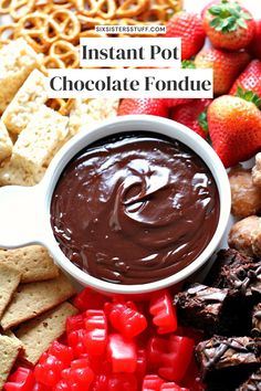 chocolate fondant in a bowl surrounded by pretzels, strawberries and other snacks