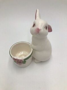 a white rabbit figurine next to a bowl