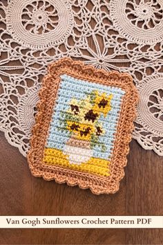 a crocheted doily with a vase of sunflowers on it